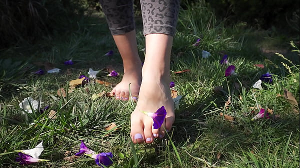 Image Crushing Flowers Barefoot In The Grass