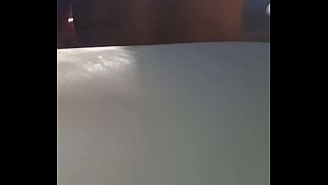 Image Sexy woman undresses on a balcony and touches her pussy in a Hot Spa inside water while being watched.