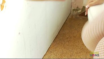 Image The brunette milf with a big ass and fake boobs joyfully gives a bj inside the local gloryhole